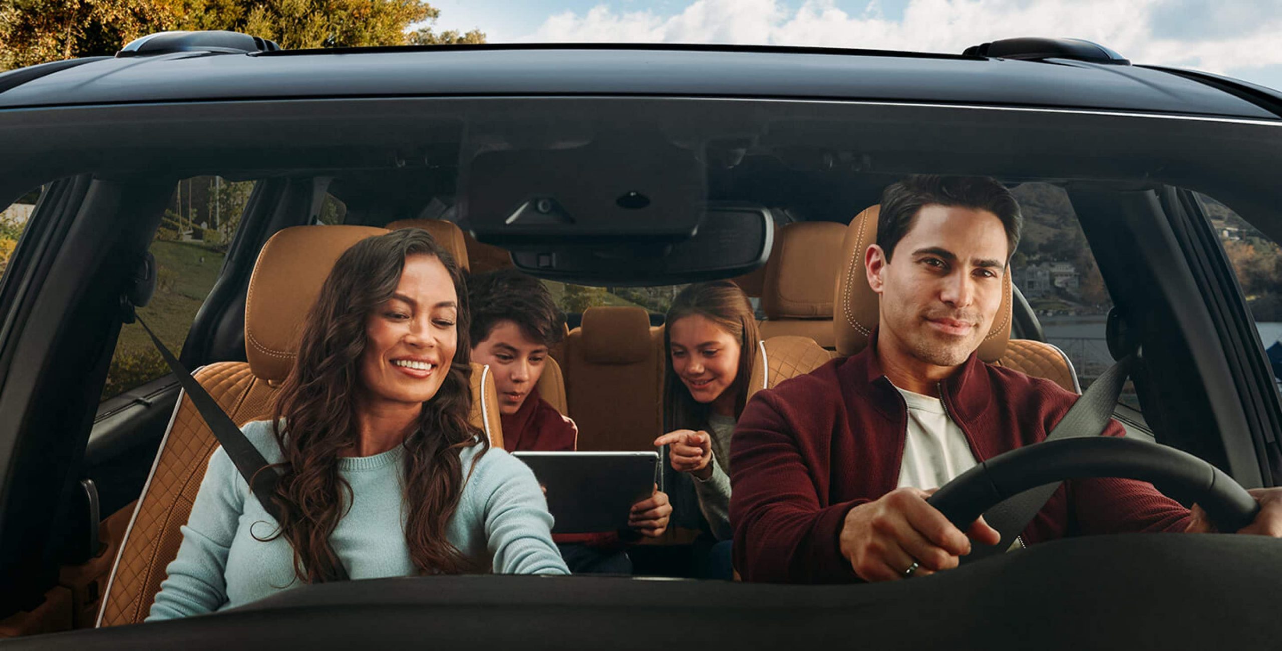 Chrysler Pacifica Family-Friendly Interior Family riding inside a Chrysler Pacifica, highlighting spacious seating and comfort for passengers.